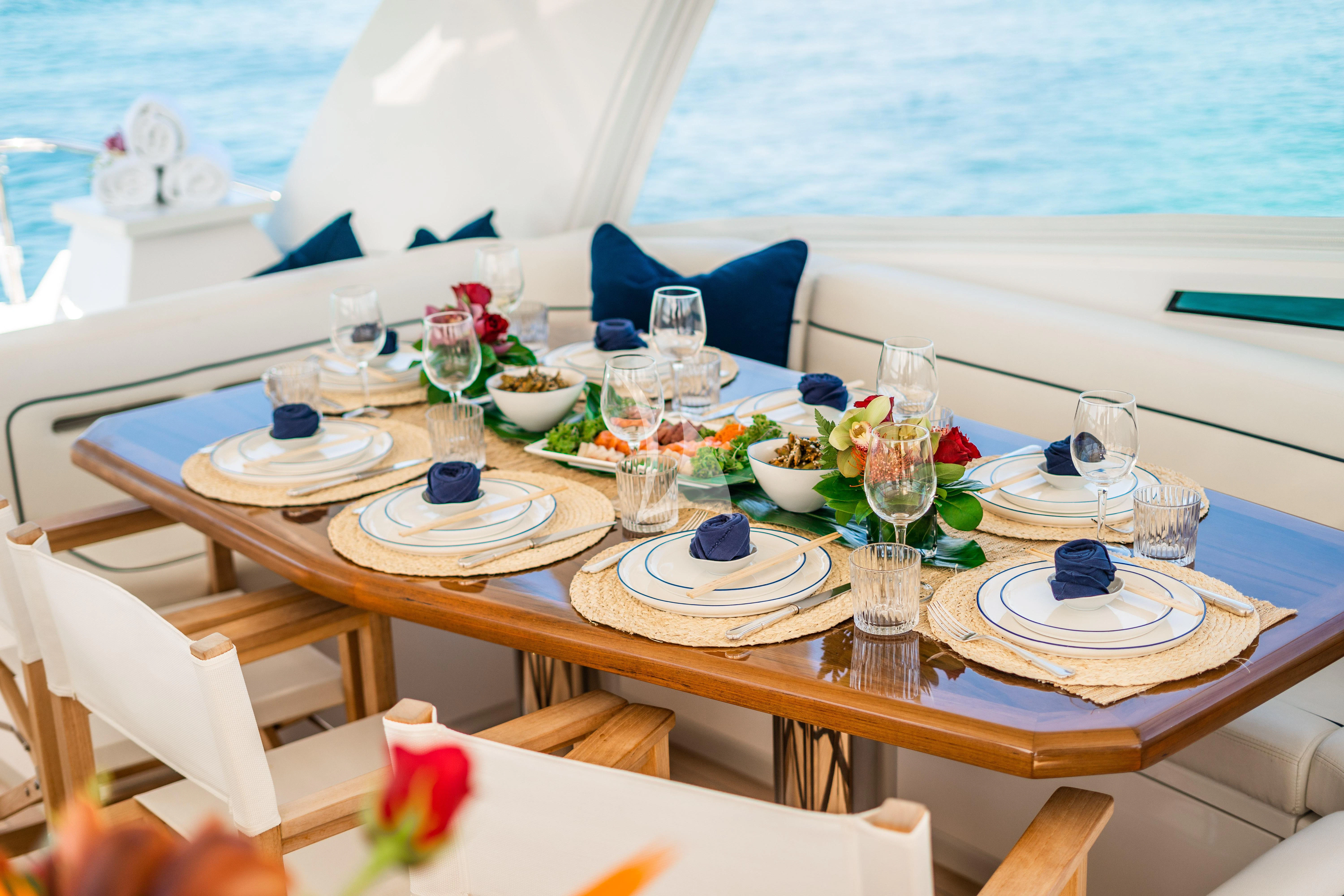 a table with plates and glasses on it aboard MARYBELLE Yacht for Sale