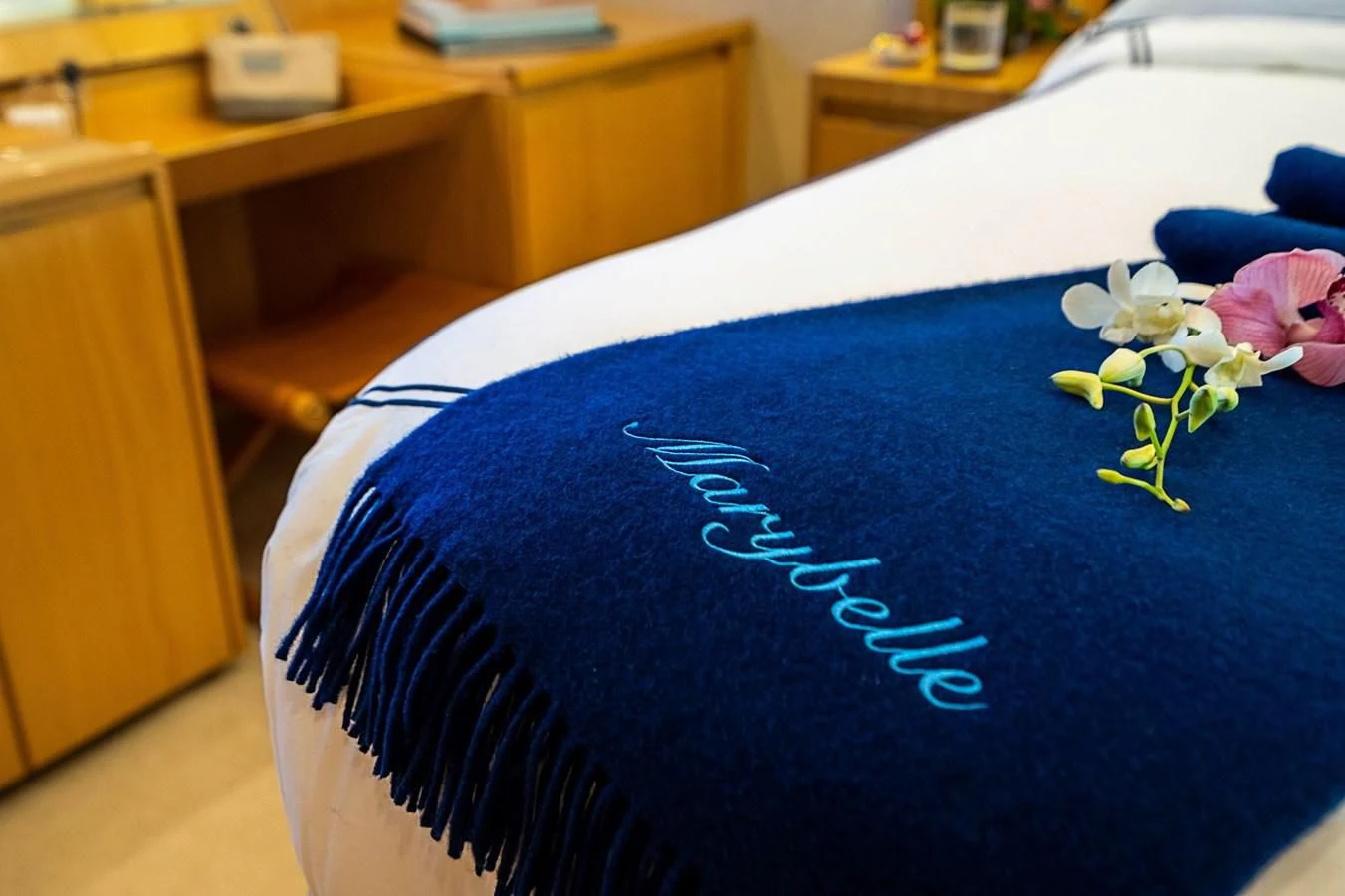a blue pillow with white flowers on it aboard MARYBELLE Yacht for Sale