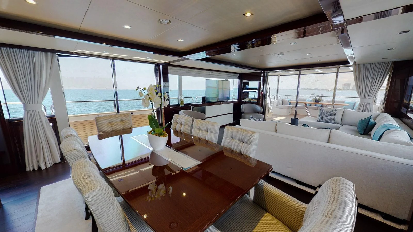 a room with a table chairs and a couch aboard PV 95 Yacht for Sale