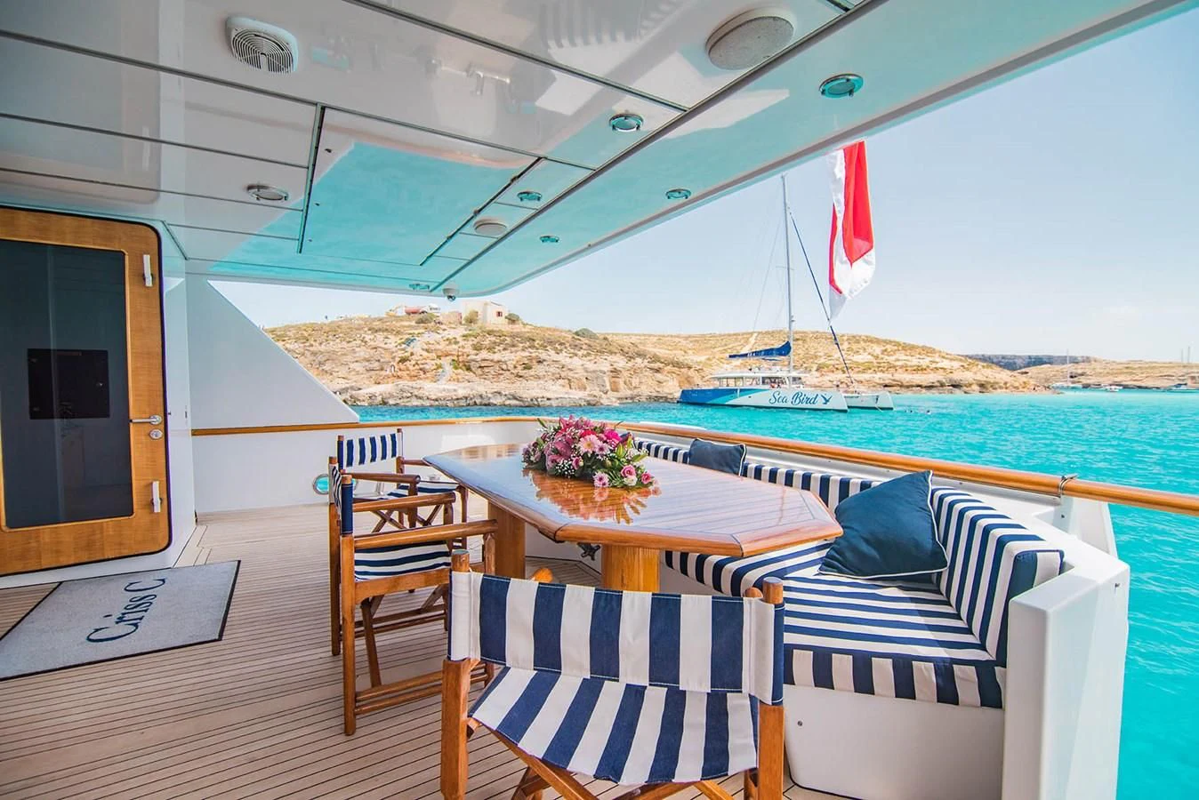 a boat with chairs and tables aboard CRISS C Yacht for Sale