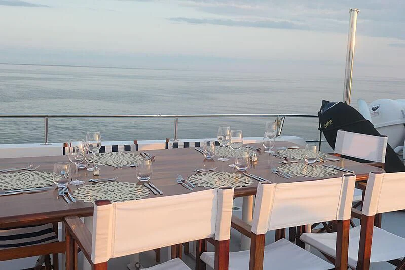 a table set for a dinner aboard CRISS C Yacht for Sale