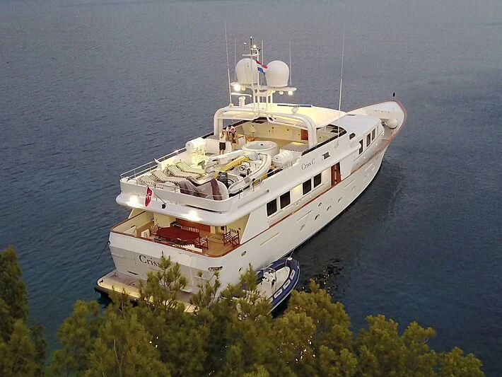 a large white ship with a blue and red stripe on it aboard CRISS C Yacht for Sale