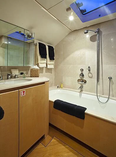 a bathroom with a bathtub and sink aboard CRISS C Yacht for Sale