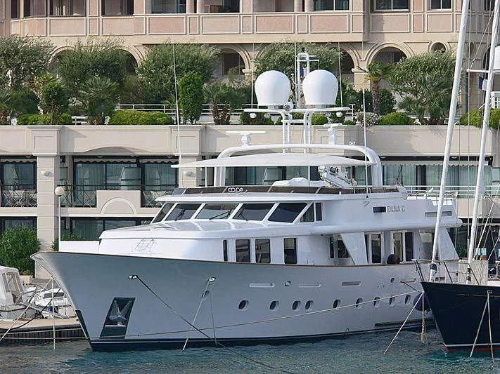 a white yacht in a harbor aboard CRISS C Yacht for Sale