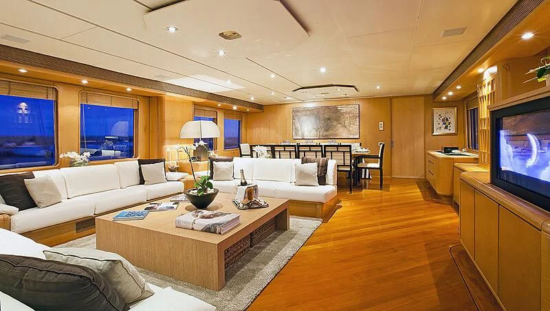 a living room with a large screen aboard CRISS C Yacht for Sale
