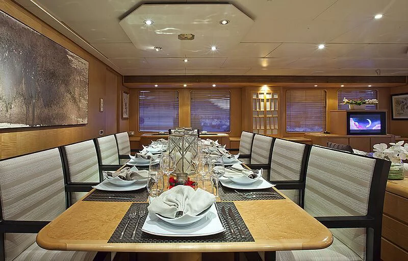 a dining room with a table set aboard CRISS C Yacht for Sale