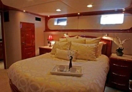 a bed with a tray of food aboard AURORA Yacht for Charter