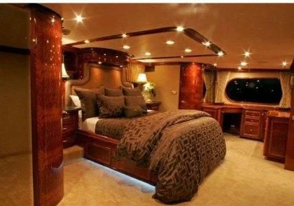 a bedroom with a bed and a television aboard AURORA Yacht for Charter