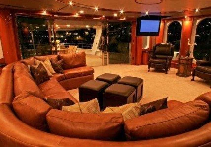 a living room with leather couches aboard AURORA Yacht for Charter