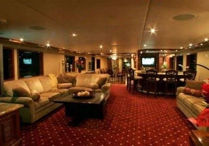 a living room with a red rug aboard AURORA Yacht for Charter