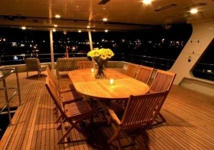 a room with chairs and tables aboard AURORA Yacht for Charter