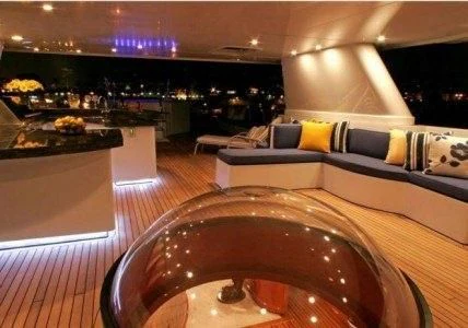 a large room with a large round table and chairs aboard AURORA Yacht for Charter