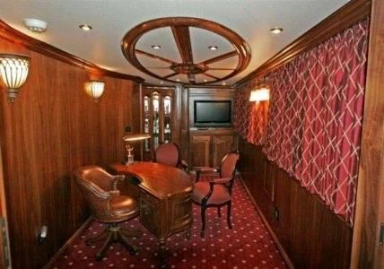 a room with a table chairs and a television aboard AURORA Yacht for Charter