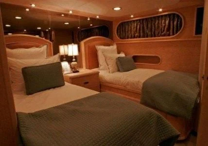 a couple of beds in a hotel room aboard AURORA Yacht for Charter
