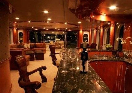 a bar with a table and chairs aboard AURORA Yacht for Charter