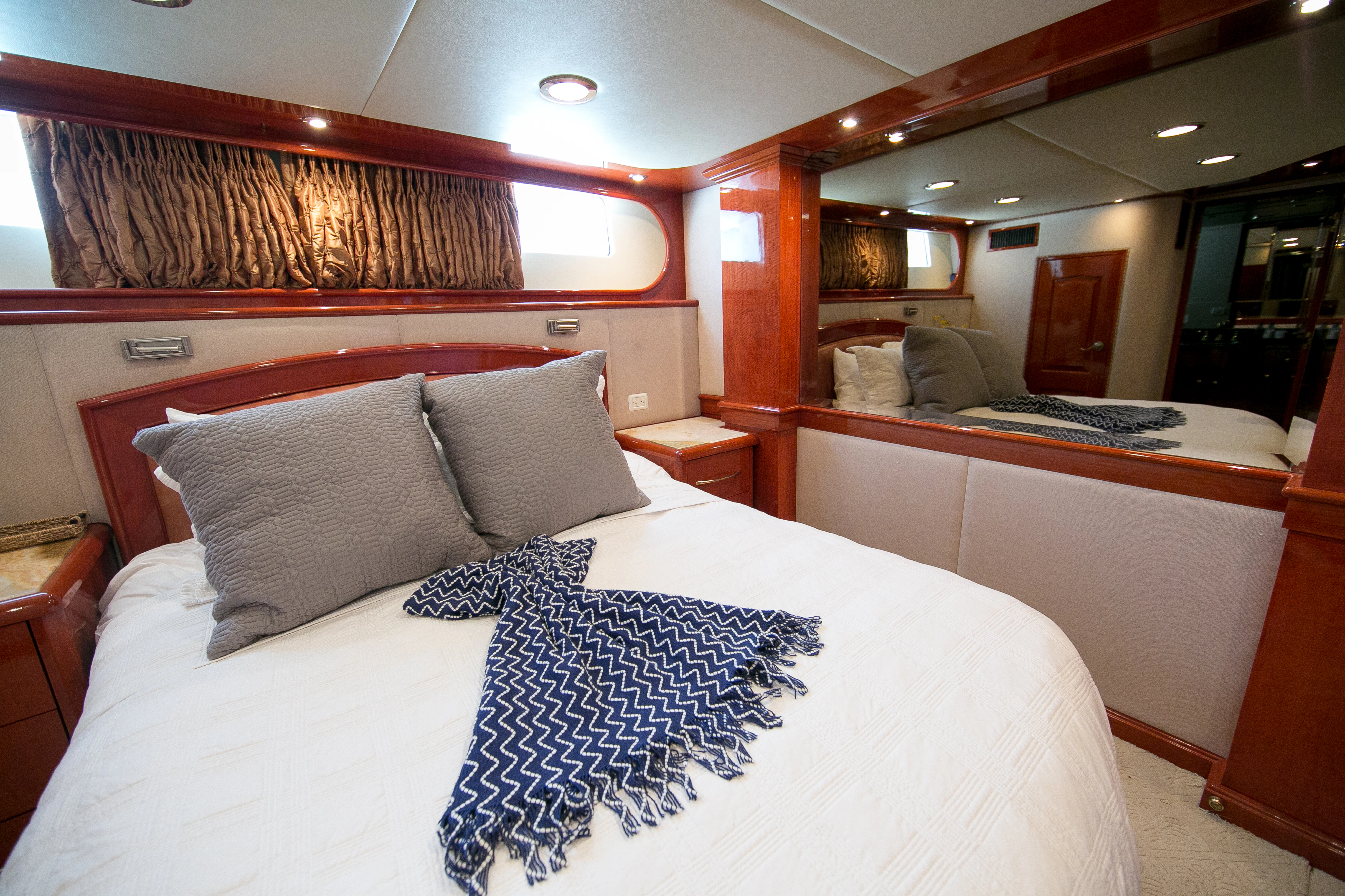 a bed with white sheets aboard AURORA Yacht for Charter