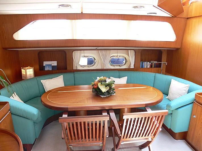 a room with a table and chairs aboard BLACK MOLLY Yacht for Sale
