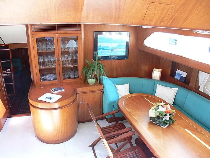 a room with a table and chairs aboard BLACK MOLLY Yacht for Sale