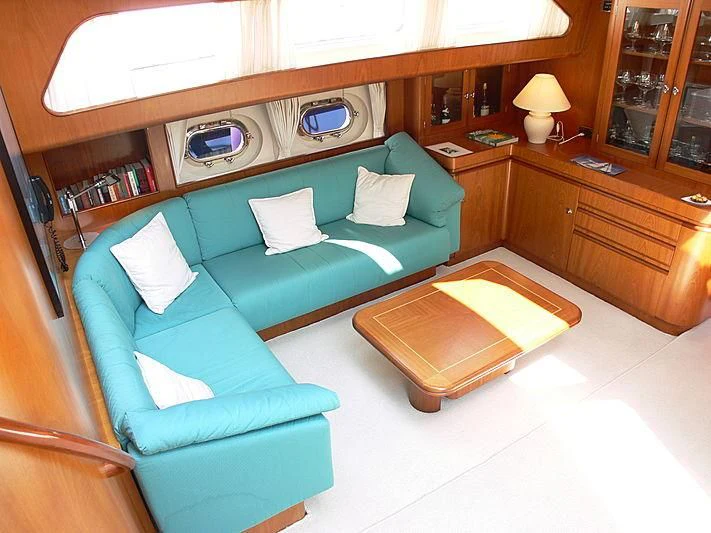 a living room with a couch and a table aboard BLACK MOLLY Yacht for Sale