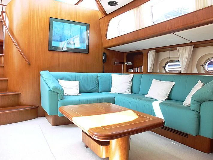 a living room with a couch and a coffee table aboard BLACK MOLLY Yacht for Sale