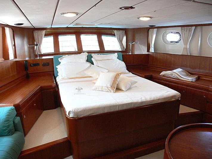 a room with a bed and a desk aboard BLACK MOLLY Yacht for Sale