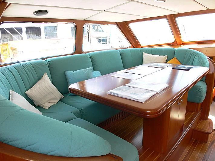 a couch with a table in front of it aboard BLACK MOLLY Yacht for Sale