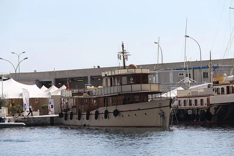 a large boat docked at a pier aboard OVER THE RAINBOW OF LONDON Yacht for Charter