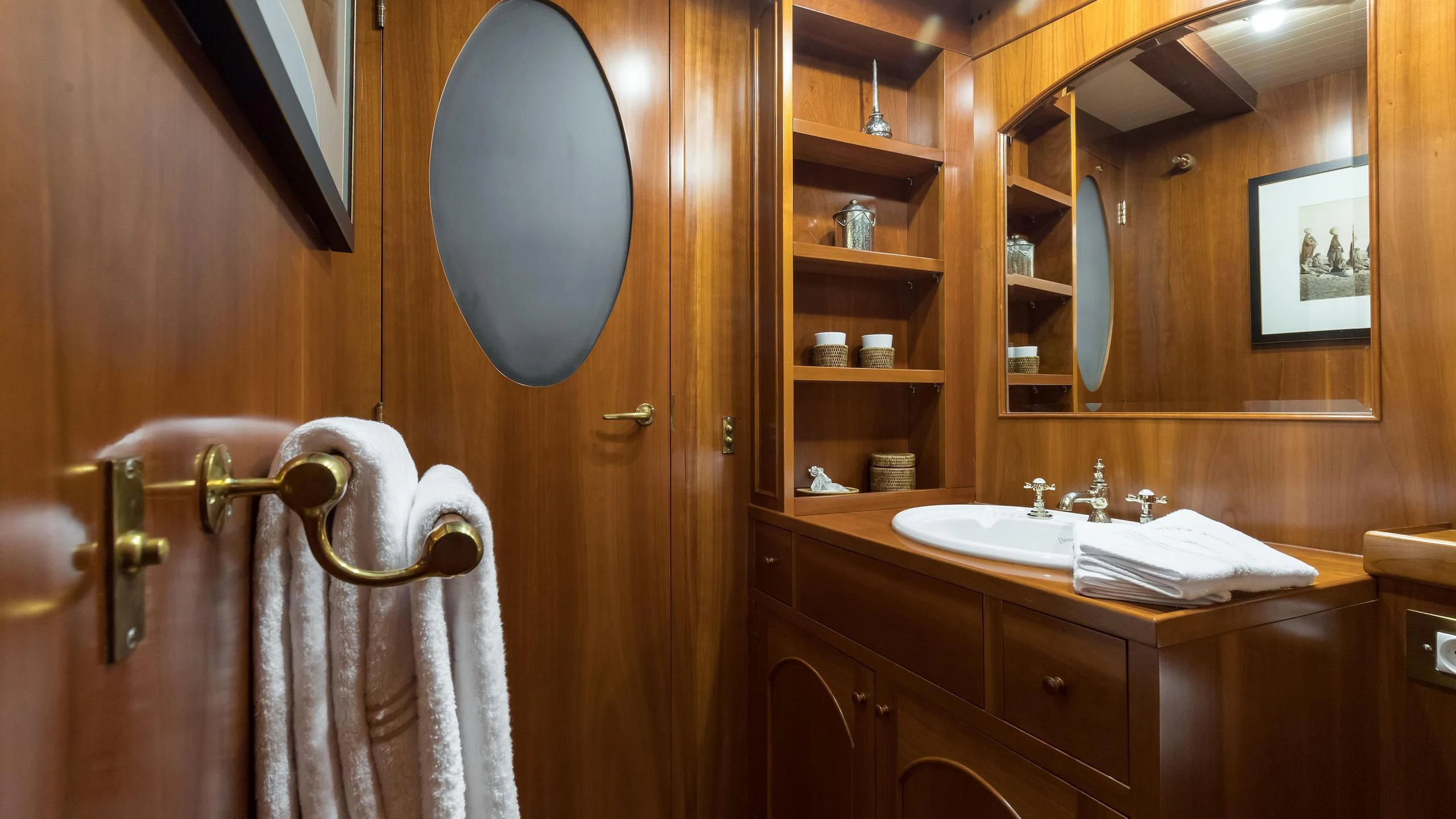 a bathroom with a large mirror aboard OVER THE RAINBOW OF LONDON Yacht for Charter