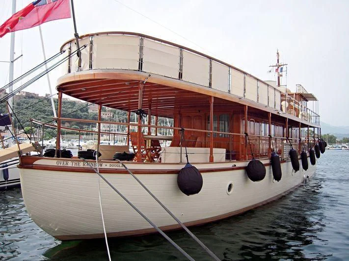 a boat with a red roof aboard OVER THE RAINBOW OF LONDON Yacht for Charter