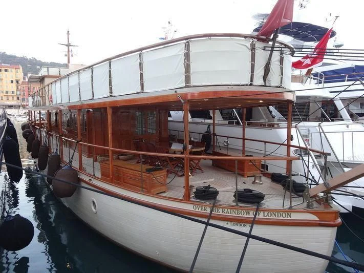 a boat with a flag on the front aboard OVER THE RAINBOW OF LONDON Yacht for Charter
