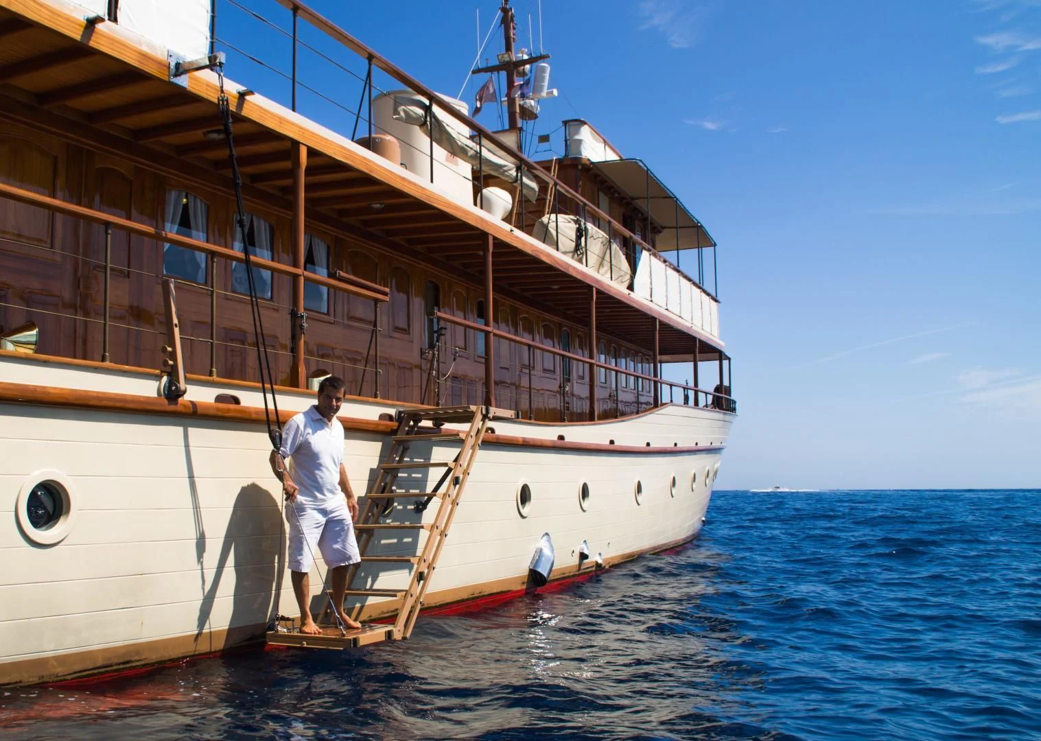 a person sitting on a boat aboard OVER THE RAINBOW OF LONDON Yacht for Charter