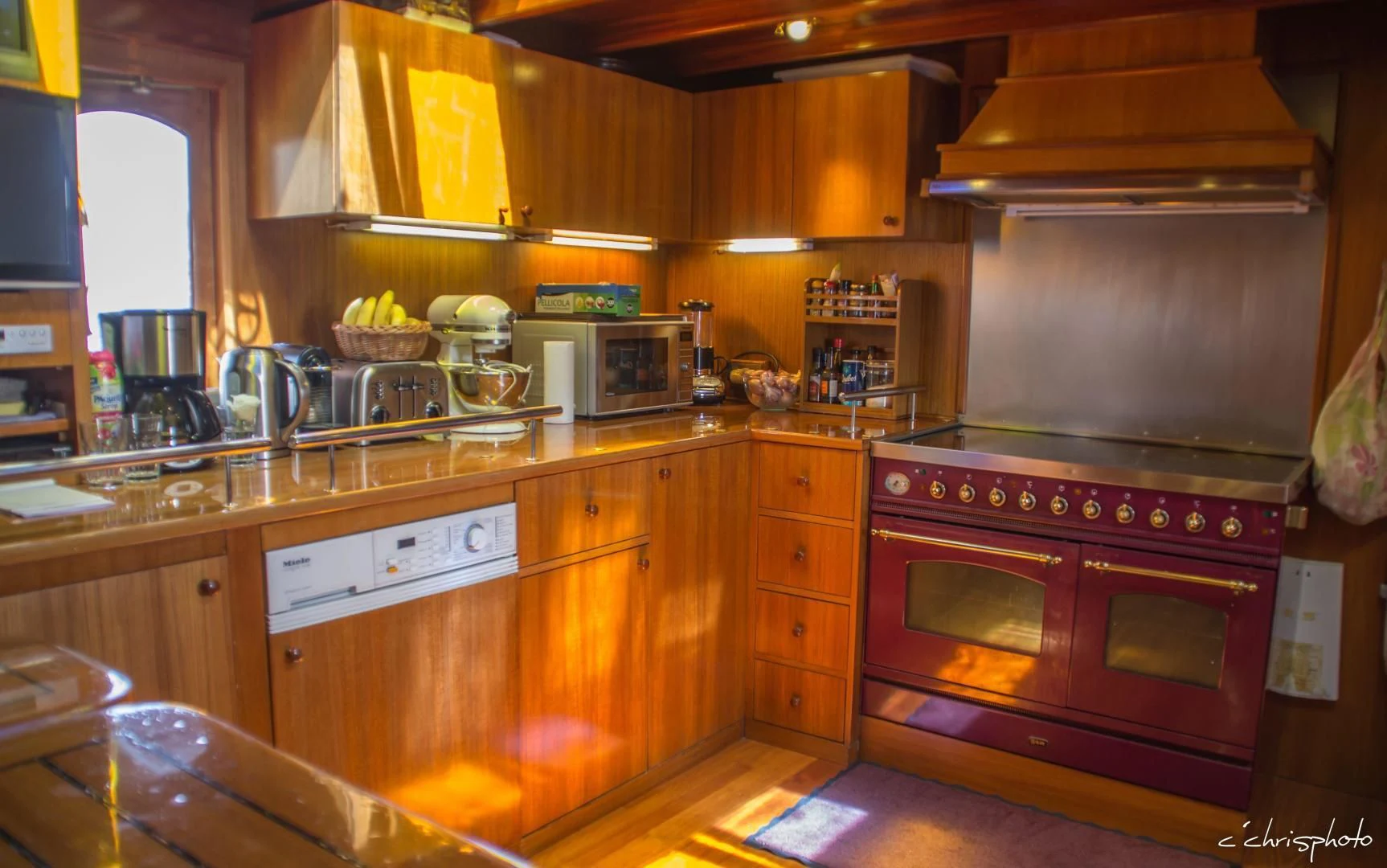 a kitchen with wooden cabinets aboard OVER THE RAINBOW OF LONDON Yacht for Charter