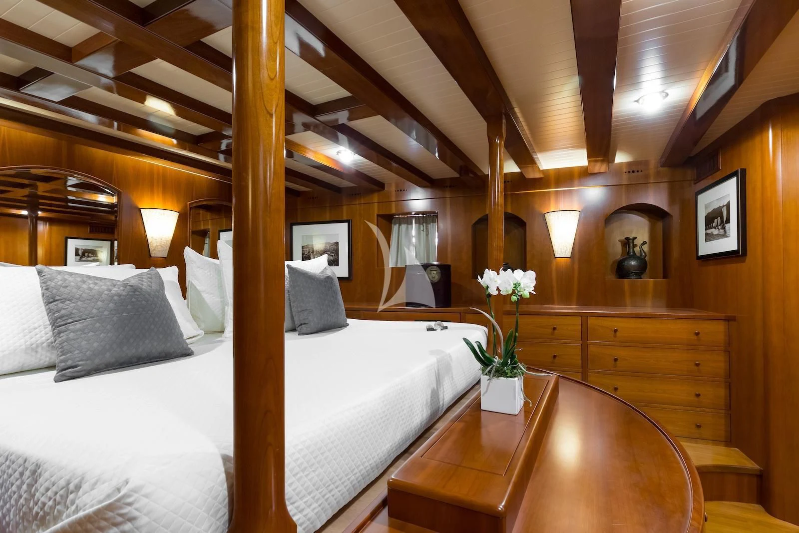 a bed with white sheets and pillows aboard OVER THE RAINBOW OF LONDON Yacht for Charter