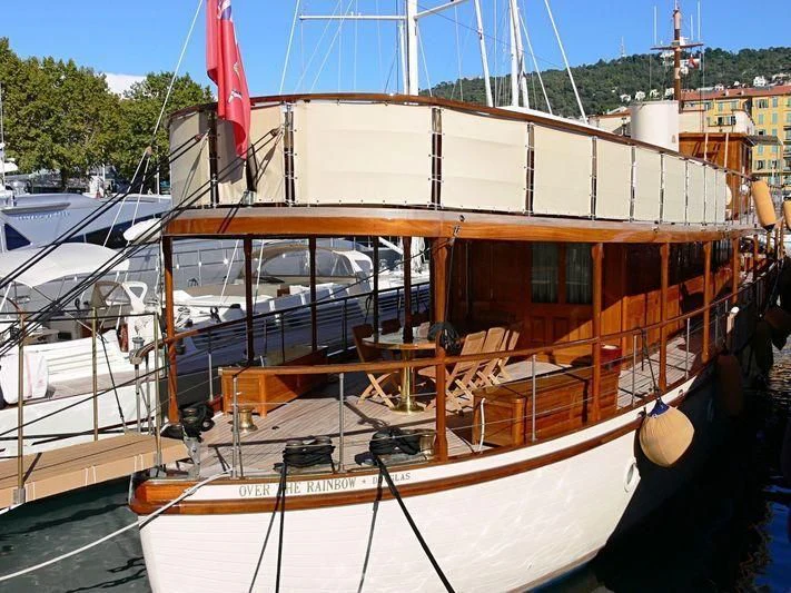 a boat docked at a pier aboard OVER THE RAINBOW OF LONDON Yacht for Charter