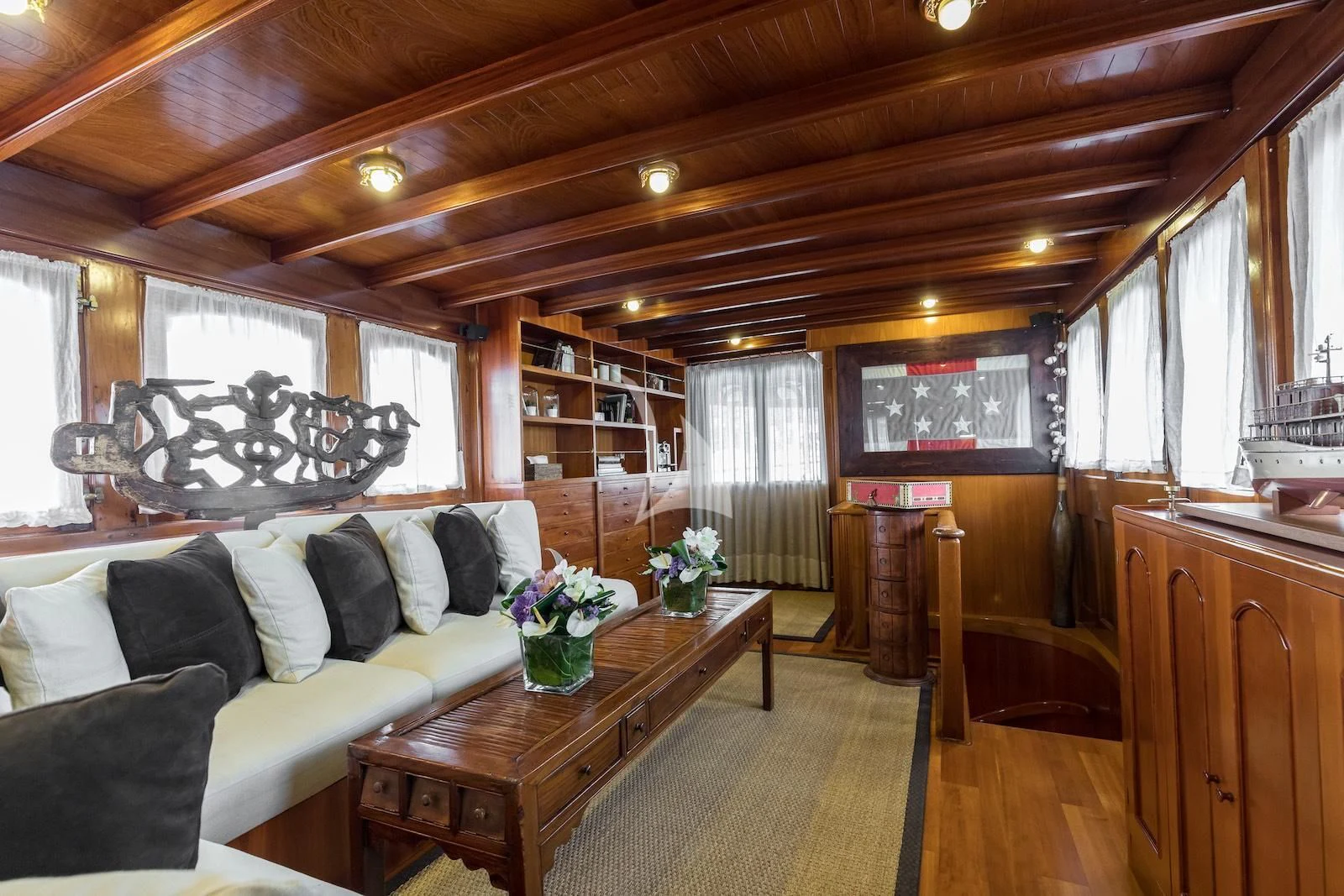 a living room with a couch and a coffee table aboard OVER THE RAINBOW OF LONDON Yacht for Charter