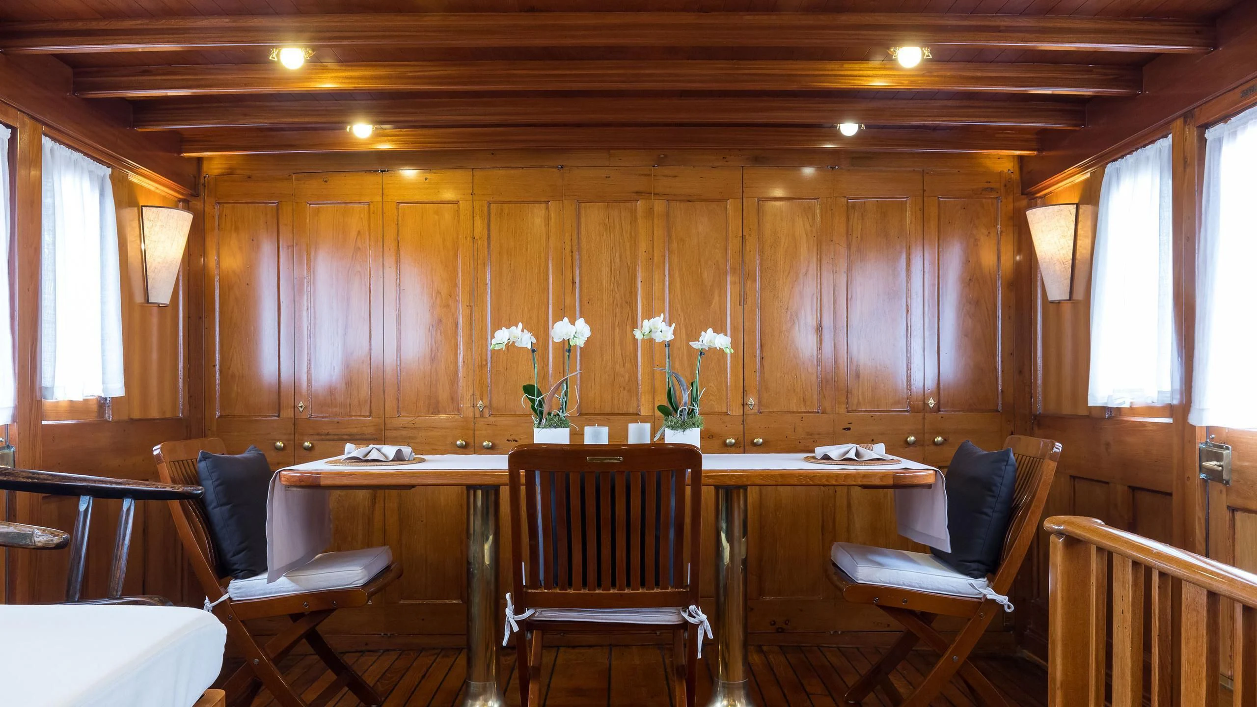 a room with chairs and tables aboard OVER THE RAINBOW OF LONDON Yacht for Charter