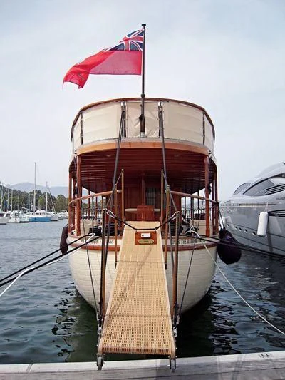 a boat with a flag on the front aboard OVER THE RAINBOW OF LONDON Yacht for Charter