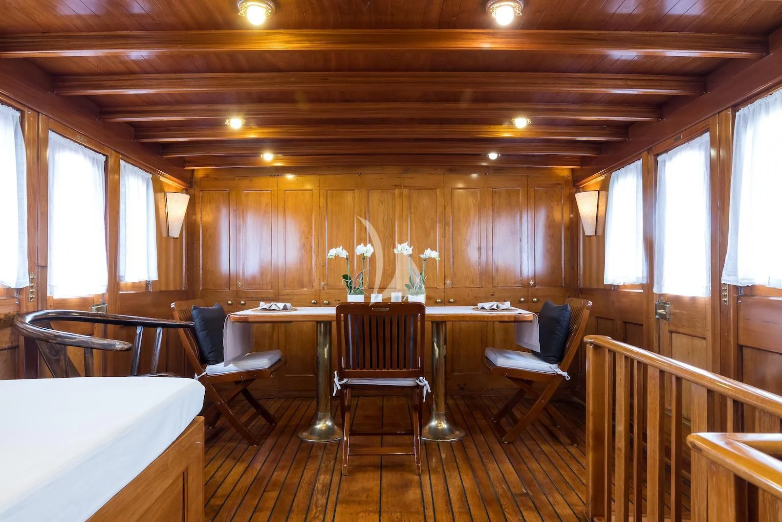 a room with tables and chairs aboard OVER THE RAINBOW OF LONDON Yacht for Charter