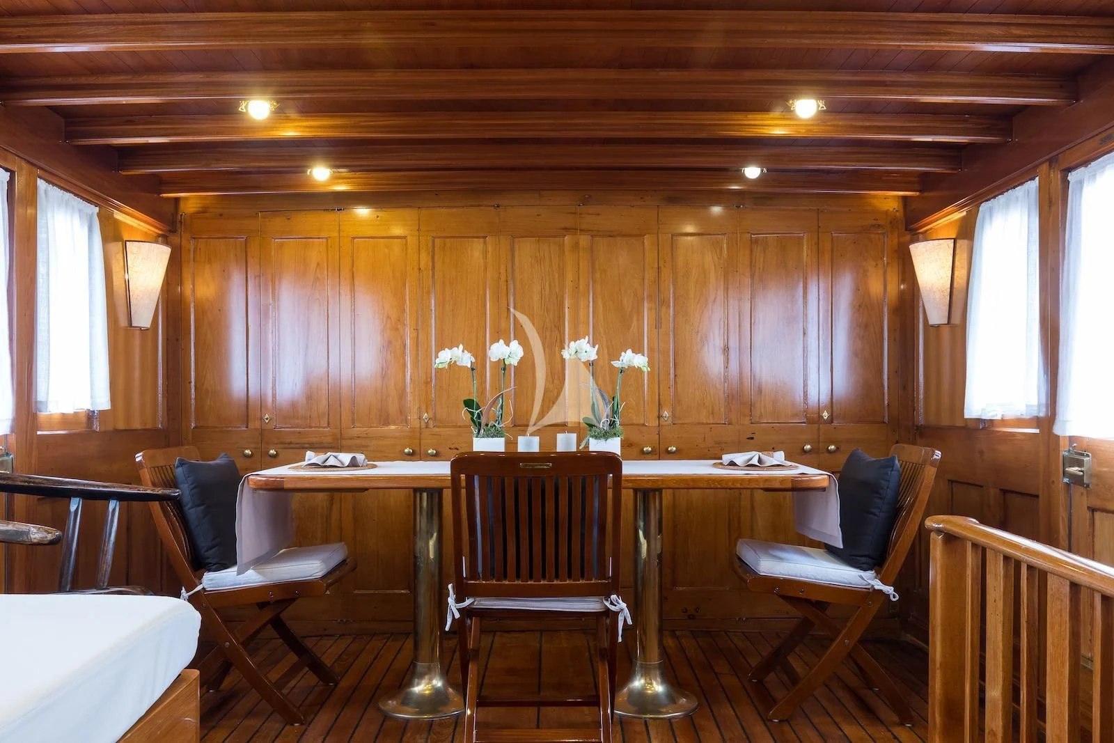a room with tables and chairs aboard OVER THE RAINBOW OF LONDON Yacht for Charter