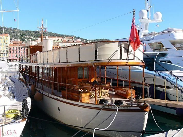 a boat docked in a harbor aboard OVER THE RAINBOW OF LONDON Yacht for Charter