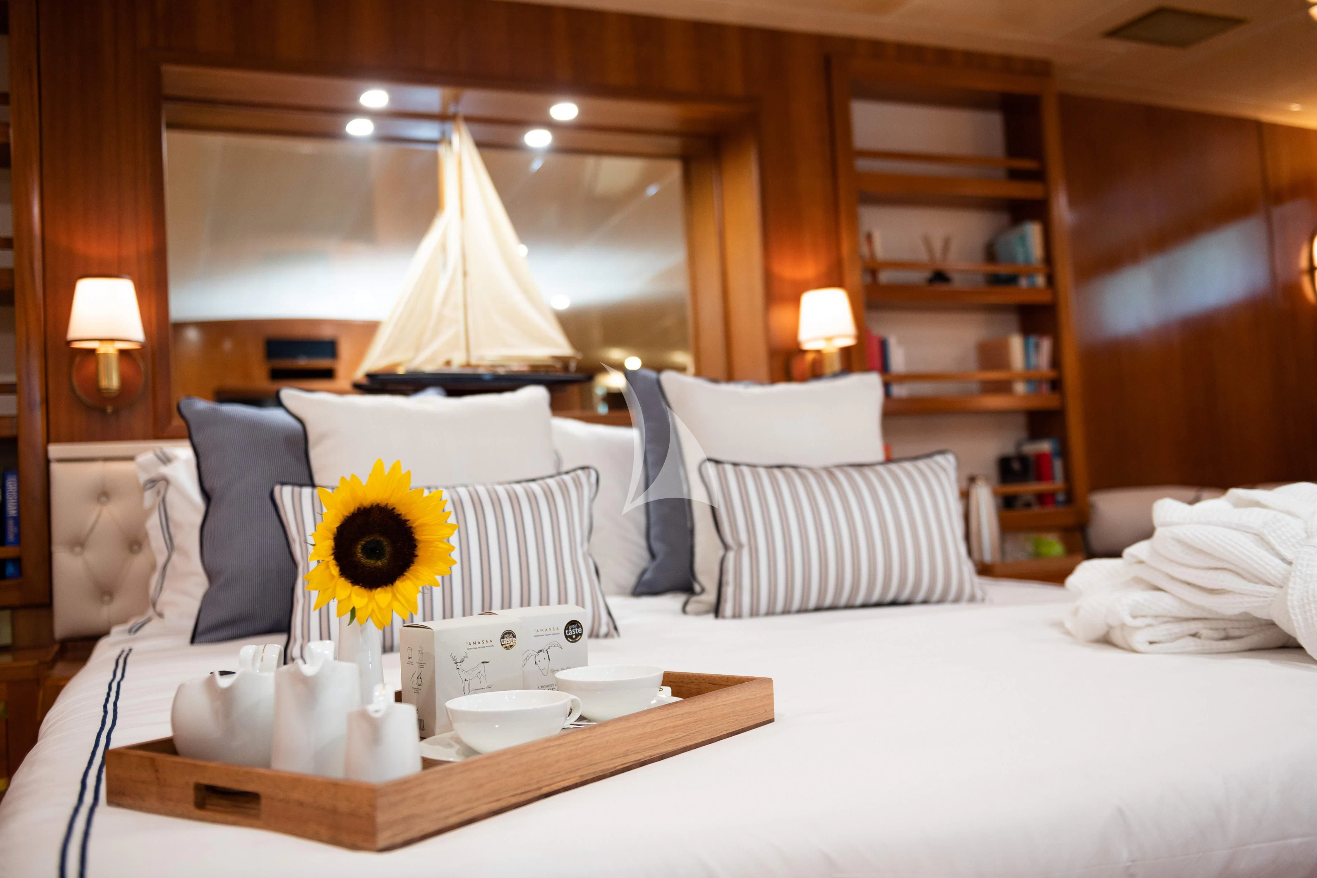 a bed with a large yellow sunflower on it aboard WIND OF FORTUNE Yacht for Charter
