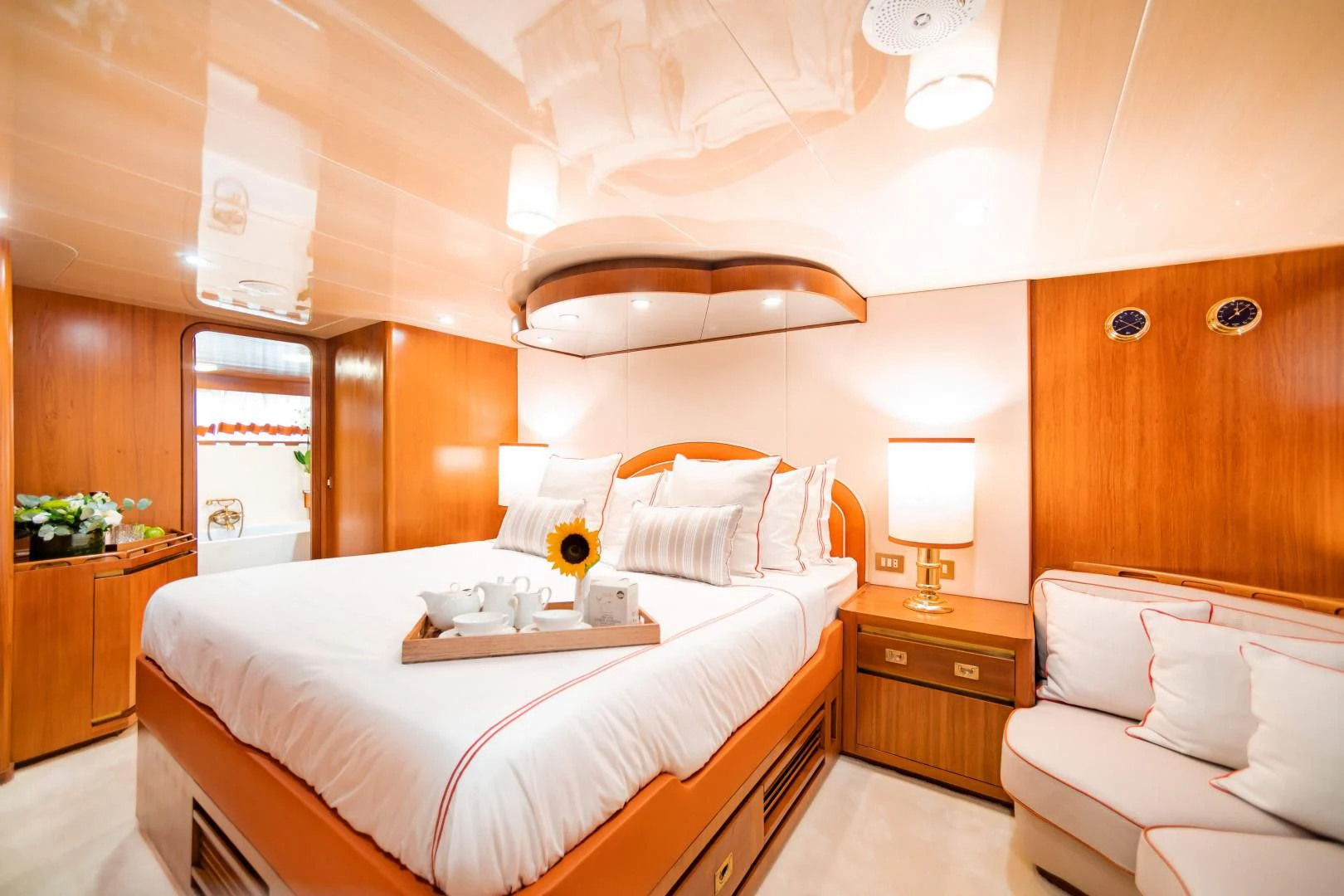 a bedroom with a bed and a table aboard WIND OF FORTUNE Yacht for Charter