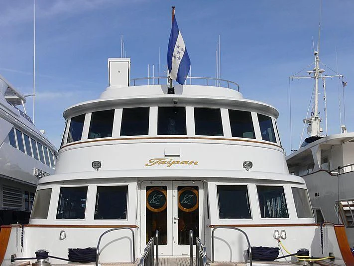 a large white boat with a flag on top aboard WIND OF FORTUNE Yacht for Charter