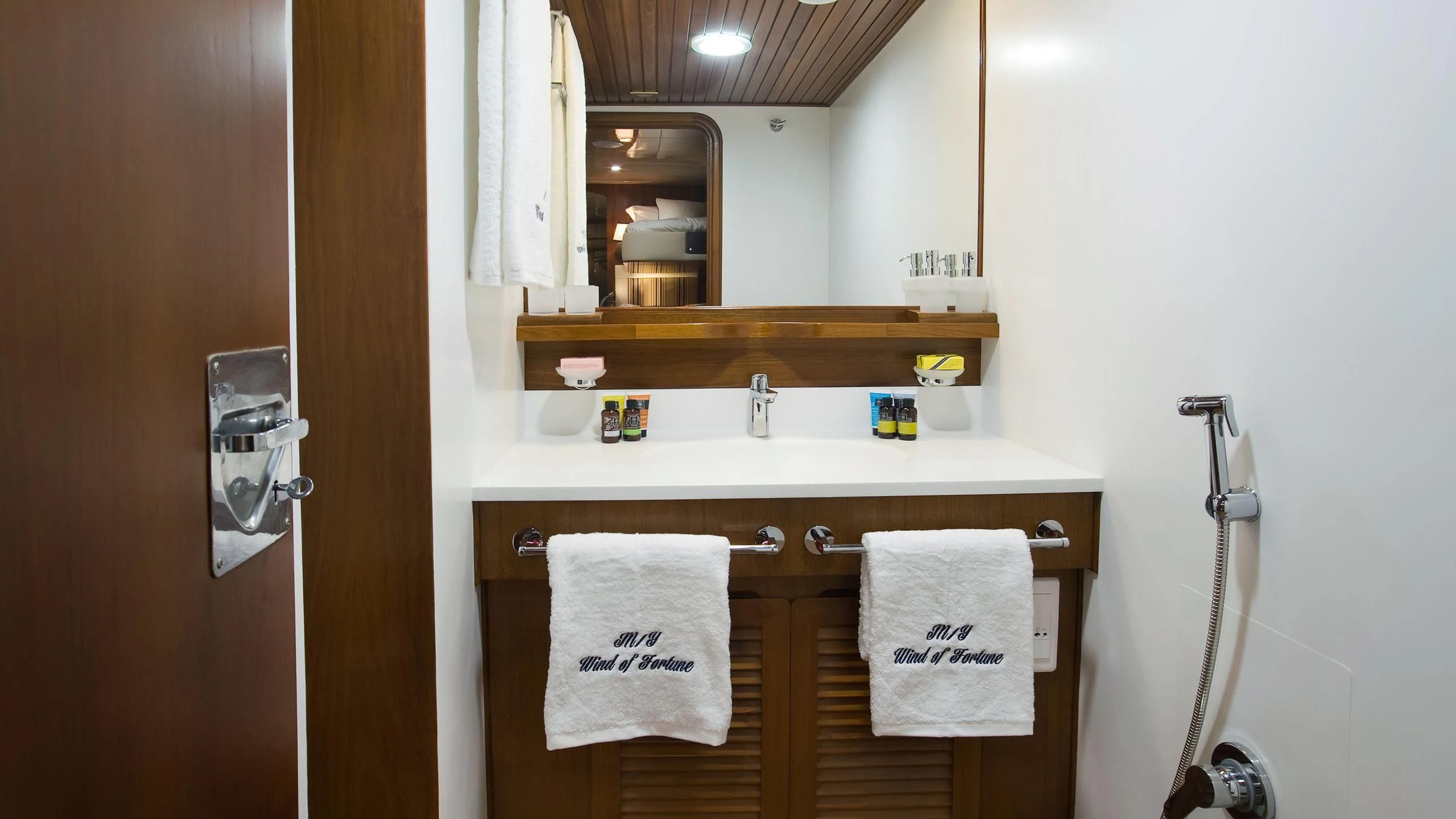 a bathroom with a sink and towels aboard WIND OF FORTUNE Yacht for Charter