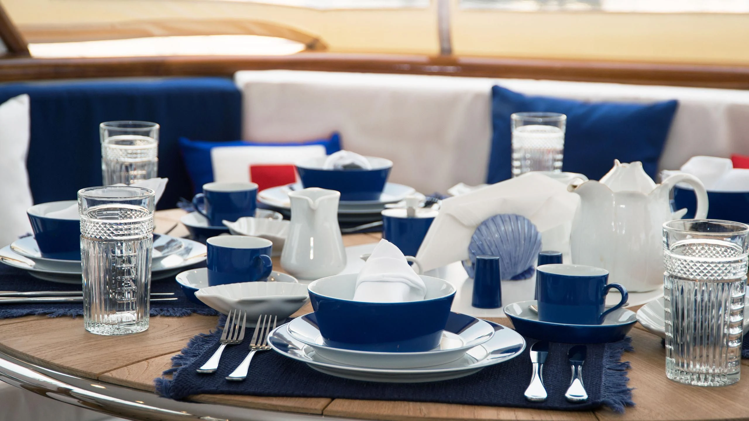a table with plates and cups on it aboard WIND OF FORTUNE Yacht for Charter