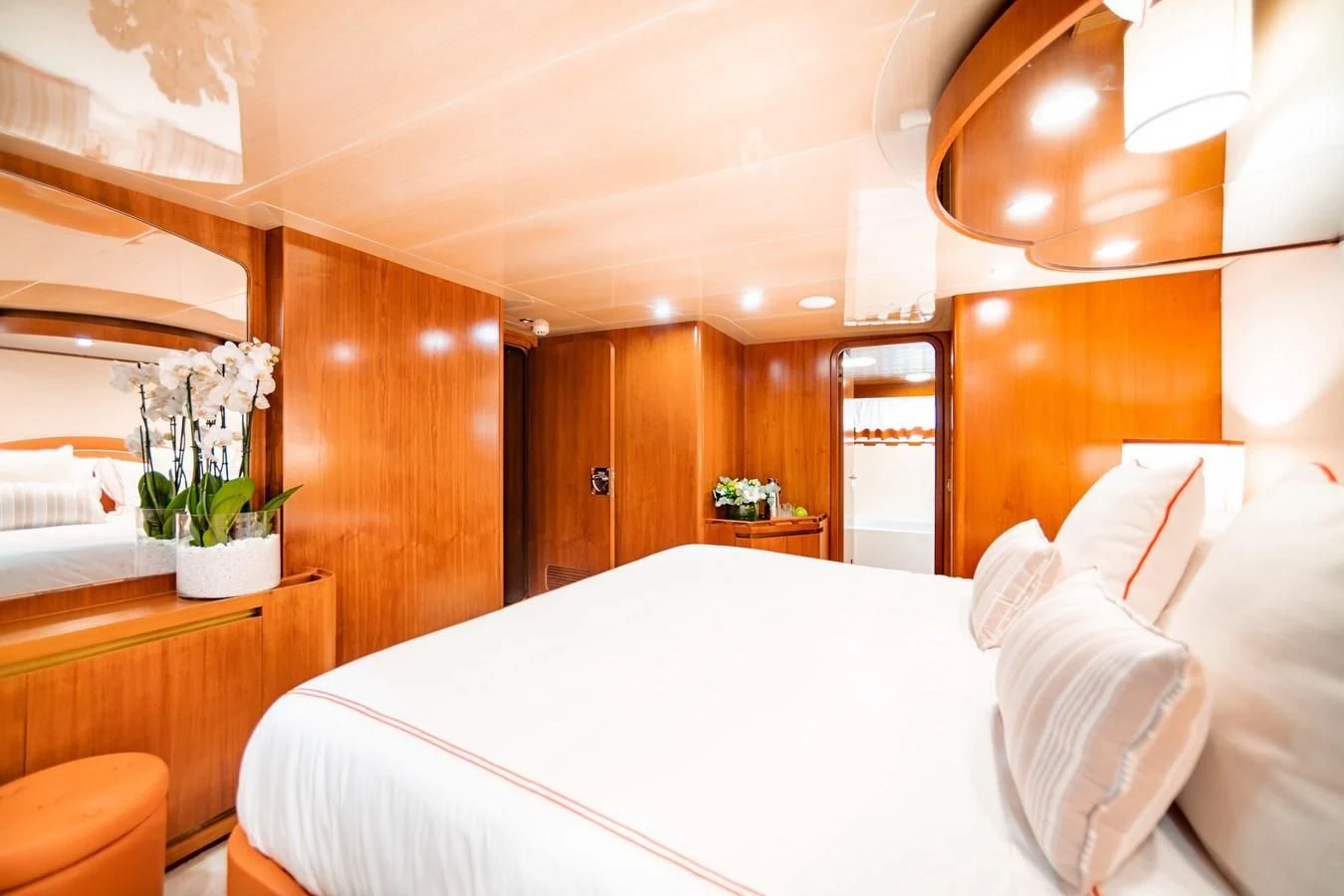 a bed with white sheets and pillows aboard WIND OF FORTUNE Yacht for Charter