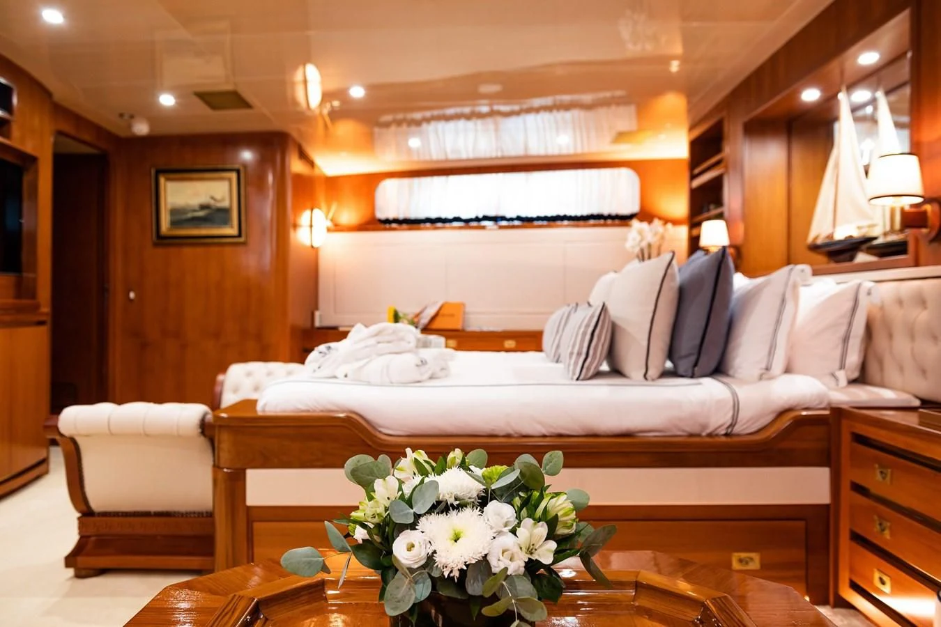 a large bed with white sheets aboard WIND OF FORTUNE Yacht for Charter