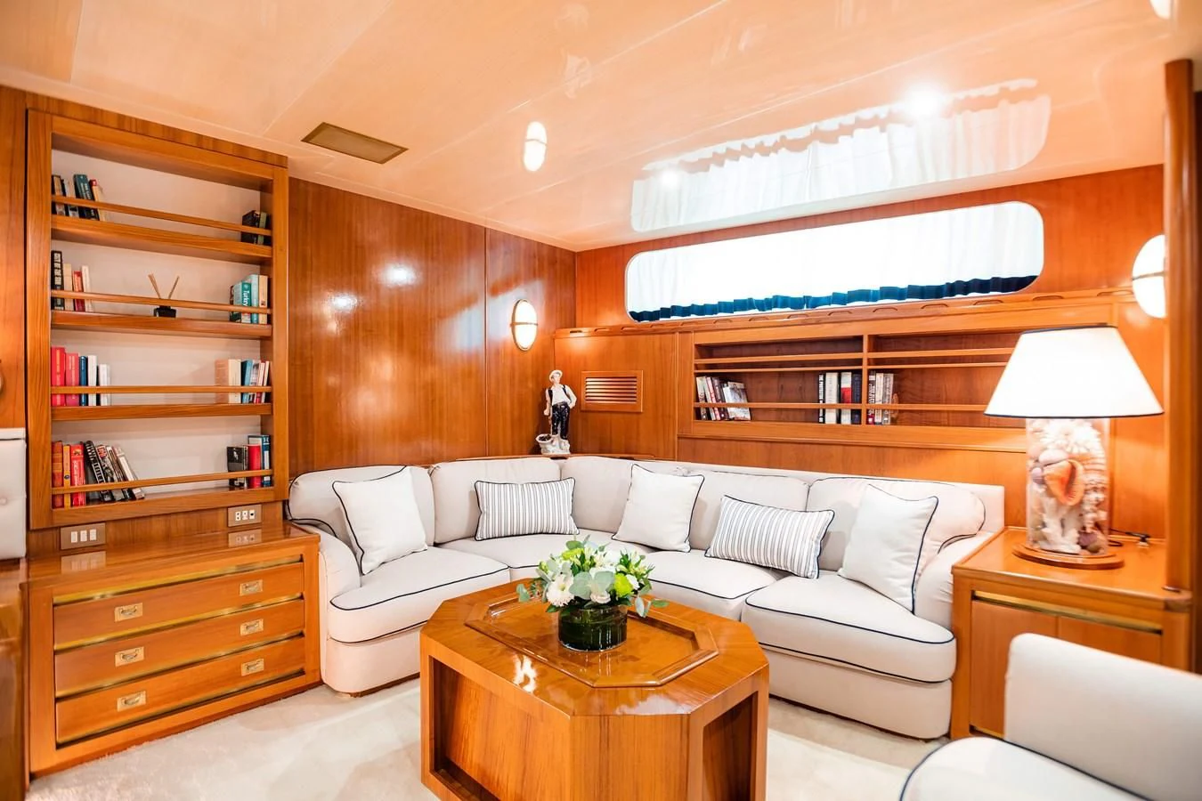 a living room with a white couch and a table aboard WIND OF FORTUNE Yacht for Charter