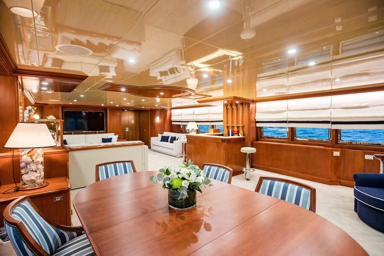 a large room with a table and chairs aboard WIND OF FORTUNE Yacht for Charter