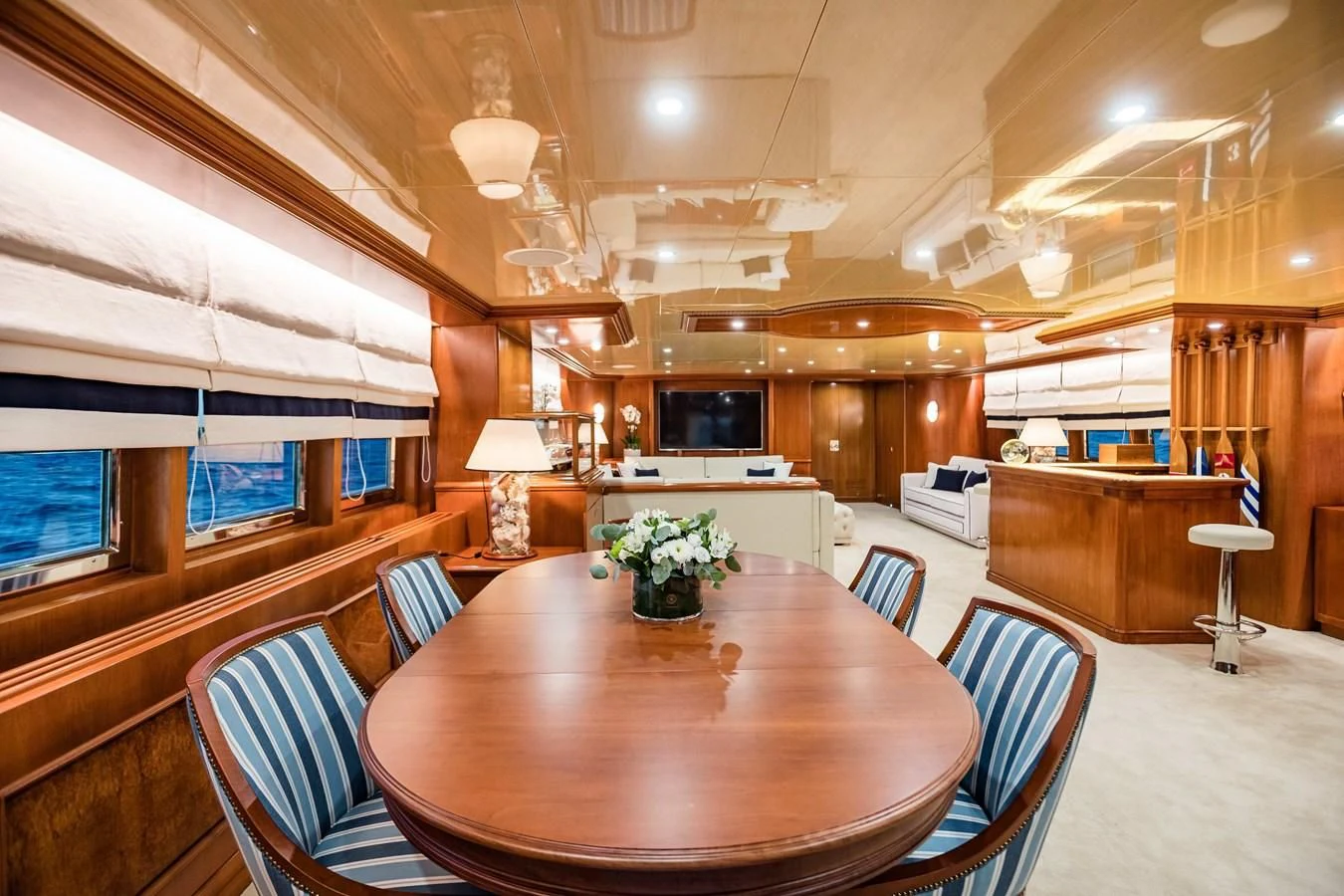 a large room with a table and chairs aboard WIND OF FORTUNE Yacht for Charter